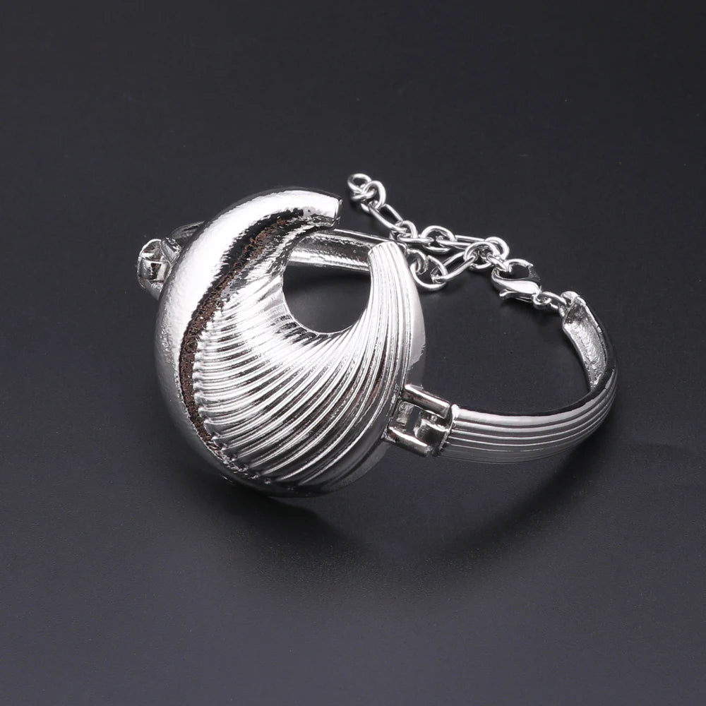 Silver plated bracelet with a shell design, featuring intricate detailing and a chain closure.