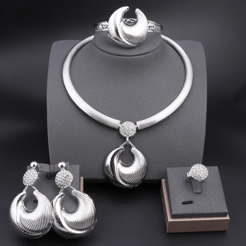 Silver plated Dubai jewelry set featuring a necklace, earrings, bracelet, and ring with intricate designs and sparkling ac...