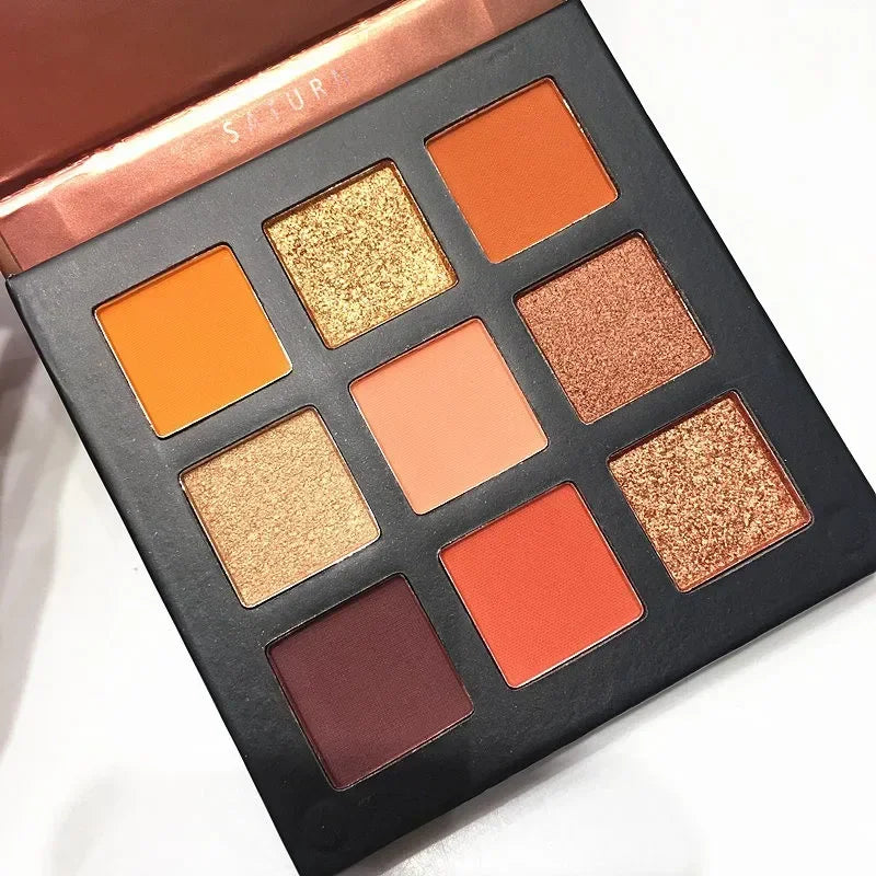 Nine-color eyeshadow palette featuring shimmer and matte shades in orange, peach, and brown tones.