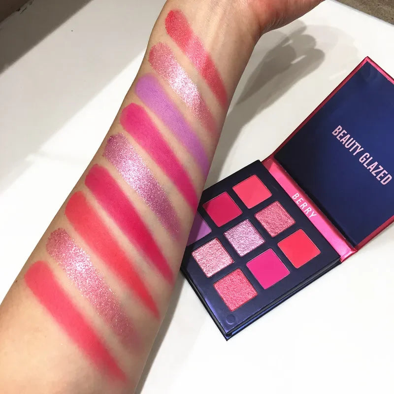 Eyeshadow palette featuring nine shades in shimmer and matte finishes, displayed on an arm with swatches.