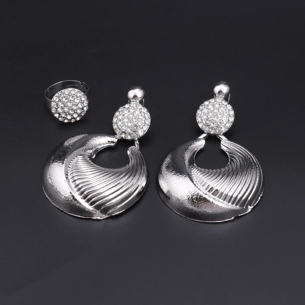 Silver plated Dubai jewelry set featuring a luxury necklace, earrings, bracelet, and ring with intricate designs.